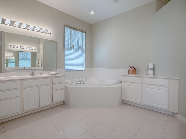 bathroom featuring tile patterned floors, vanity, and tiled tub