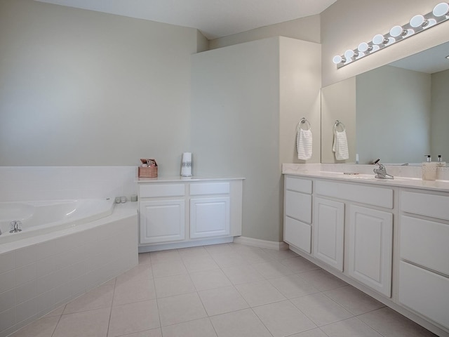 bathroom featuring tile patterned floors, vanity, and tiled tub