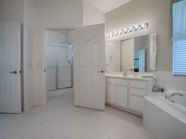 bathroom with independent shower and bath, vanity, lofted ceiling, and tile patterned floors