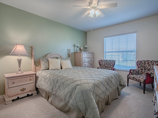 bedroom featuring light colored carpet and ceiling fan