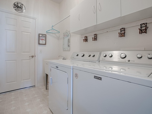 laundry room with cabinets, separate washer and dryer, and light tile patterned floors