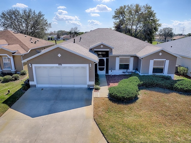 ranch-style home with a garage and a front lawn