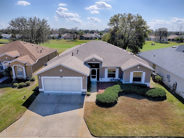 ranch-style home featuring a garage and a front lawn