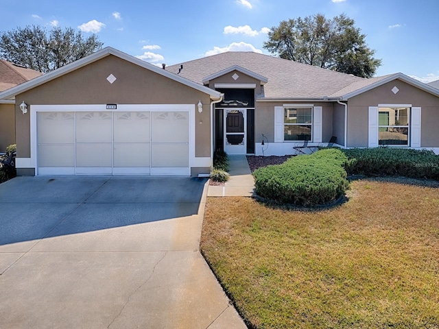 single story home featuring a garage and a front yard