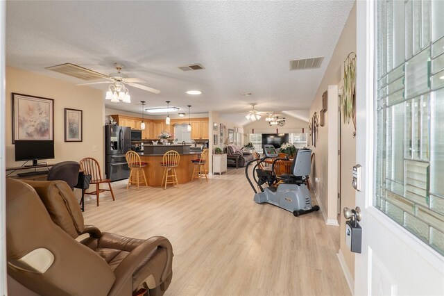 8373 SE 177th Bartram Loop, The Villages, FL 32162 - living room featuring ceiling fan, light hardwood / wood-style flooring, and a textured ceiling