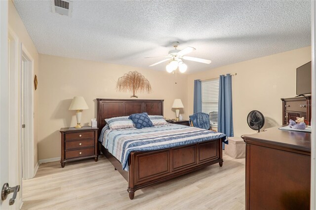 8373 SE 177th Bartram Loop, The Villages, FL 32162 - bedroom featuring ceiling fan, a textured ceiling, and light wood-type flooring