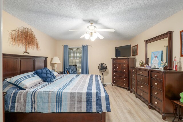 8373 SE 177th Bartram Loop, The Villages, FL 32162 - bedroom featuring ceiling fan, light hardwood / wood-style flooring, and a textured ceiling