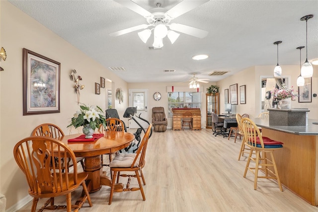 8373 SE 177th Bartram Loop, The Villages, FL 32162 - dining area with ceiling fan, a textured ceiling, and light wood-type flooring