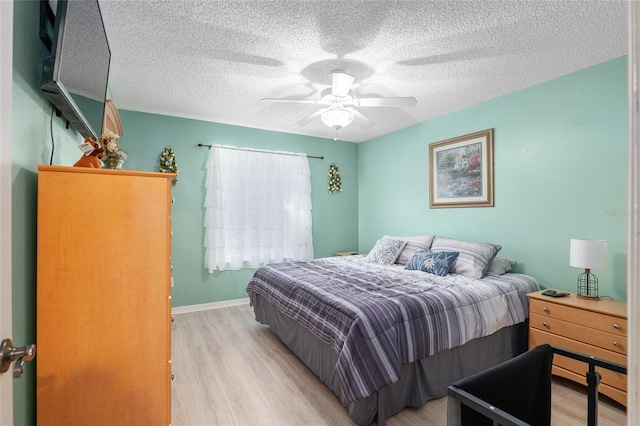 8373 SE 177th Bartram Loop, The Villages, FL 32162 - bedroom featuring ceiling fan, a textured ceiling, and light wood-type flooring