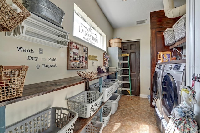 kitchen with light tile patterned flooring and washing machine and dryer