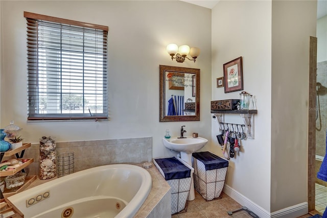 bathroom featuring tile patterned floors, shower with separate bathtub, and sink