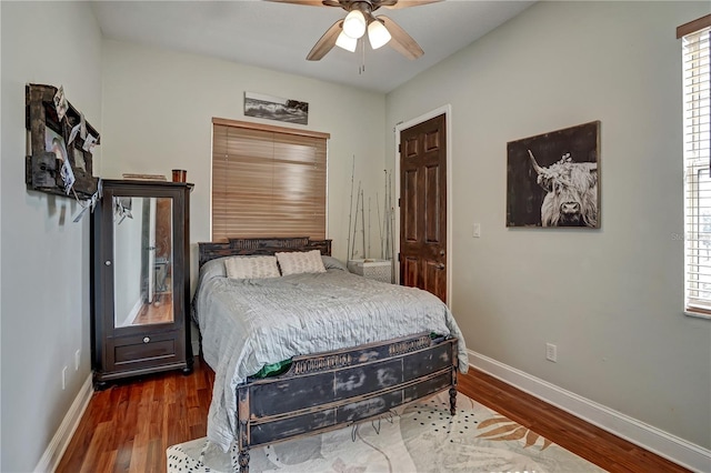 bedroom featuring dark hardwood / wood-style floors and ceiling fan