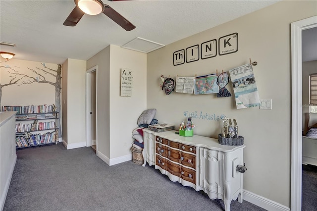 interior space featuring dark carpet and a textured ceiling