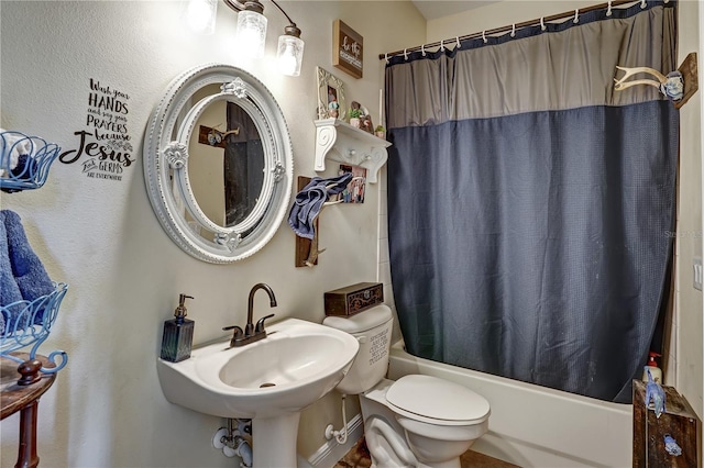 full bathroom with sink, shower / bathtub combination with curtain, and toilet