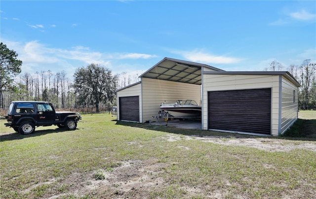 garage featuring a lawn and a carport