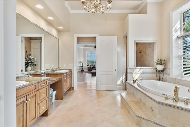 bathroom featuring vanity, tiled tub, crown molding, and plenty of natural light