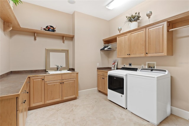 laundry area featuring cabinets, sink, and washer and dryer