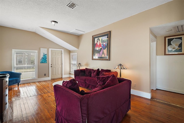 living room with hardwood / wood-style flooring and a textured ceiling