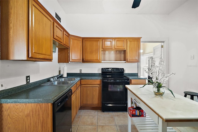 kitchen featuring light tile patterned floors, sink, and black appliances