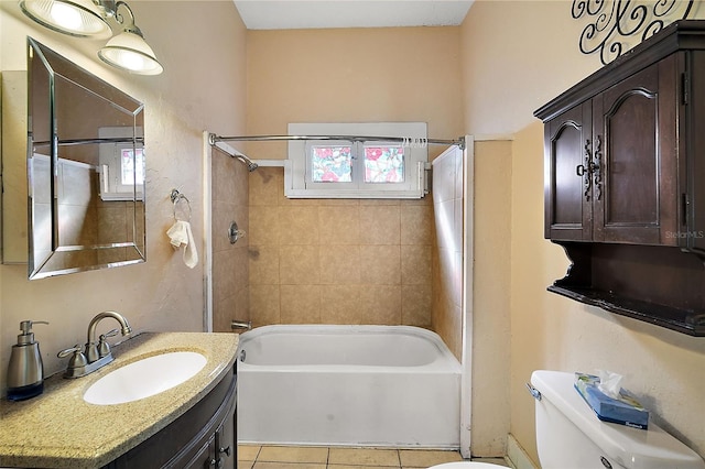 full bathroom featuring tiled shower / bath combo, vanity, tile patterned flooring, and toilet