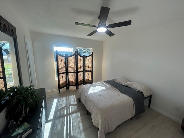 654 NW 9th Ave, Webster, FL 33597 - bedroom featuring multiple windows, a ceiling fan, and light wood-style flooring