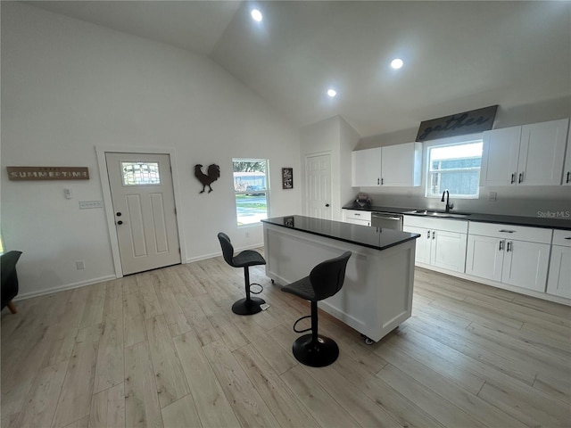 654 NW 9th Ave, Webster, FL 33597 - kitchen featuring stainless steel dishwasher, dark countertops, a kitchen breakfast bar, a kitchen island, and recessed lighting