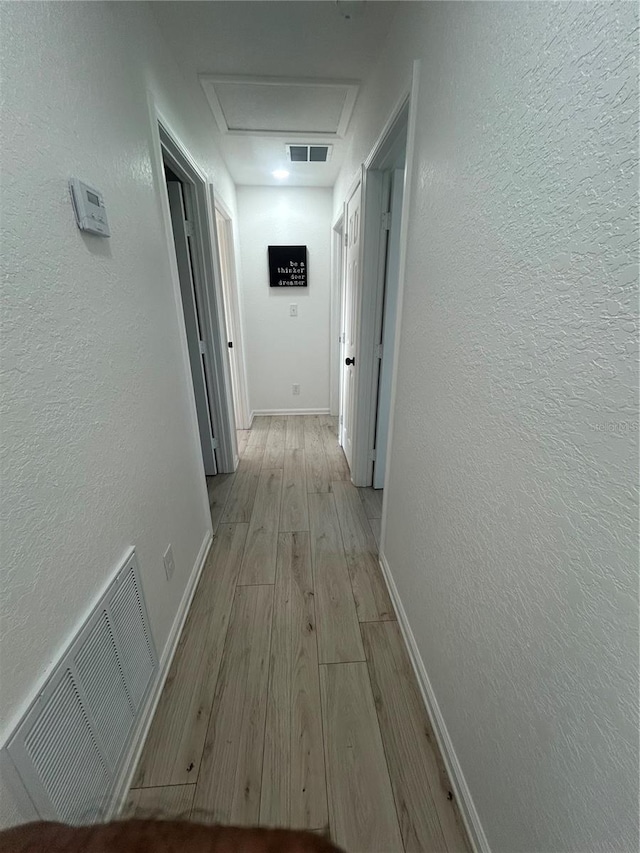 654 NW 9th Ave, Webster, FL 33597 - hall with wood finished floors, a textured wall, and attic access