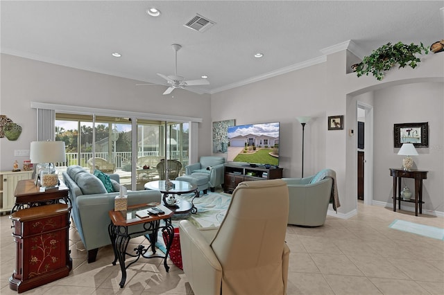 living room featuring light tile patterned flooring, ceiling fan, and crown molding