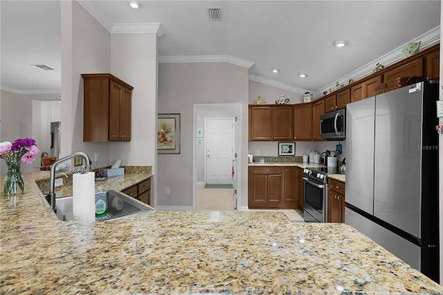 kitchen featuring kitchen peninsula, sink, ornamental molding, vaulted ceiling, and appliances with stainless steel finishes