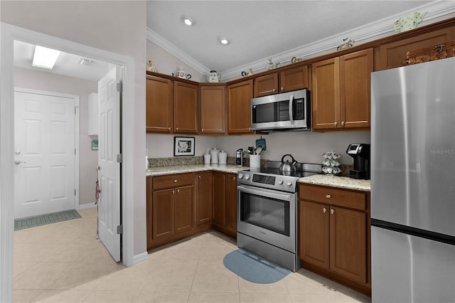 kitchen featuring light tile patterned flooring, crown molding, stainless steel appliances, and light stone counters