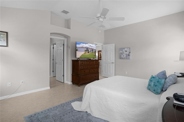 tiled bedroom with ceiling fan and vaulted ceiling