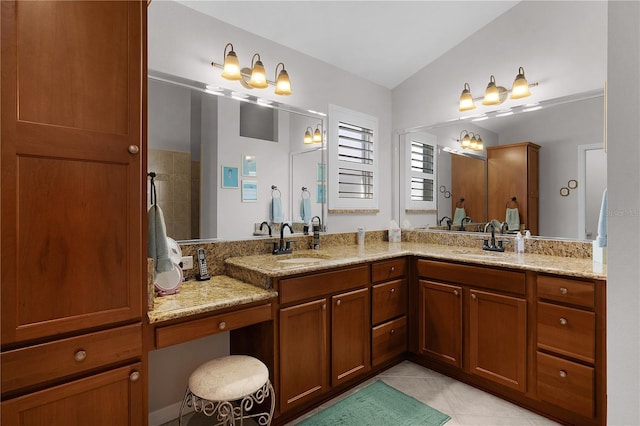 bathroom featuring a shower, tile patterned floors, lofted ceiling, and vanity