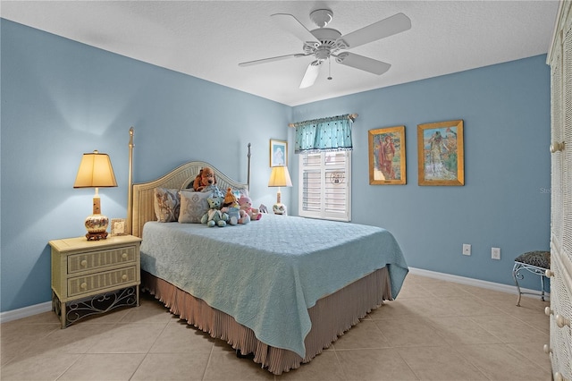 tiled bedroom featuring ceiling fan and a textured ceiling