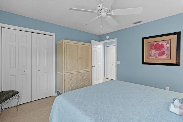 tiled bedroom featuring ceiling fan