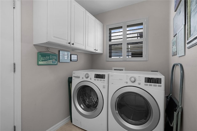 washroom featuring cabinets and washing machine and clothes dryer