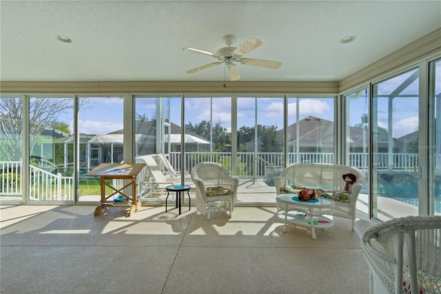 sunroom featuring ceiling fan and a healthy amount of sunlight