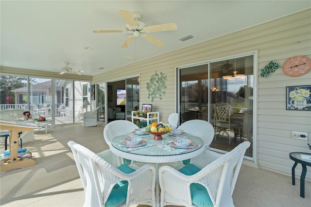 sunroom featuring ceiling fan