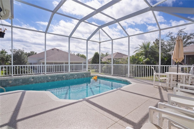 view of swimming pool featuring a patio and a lanai