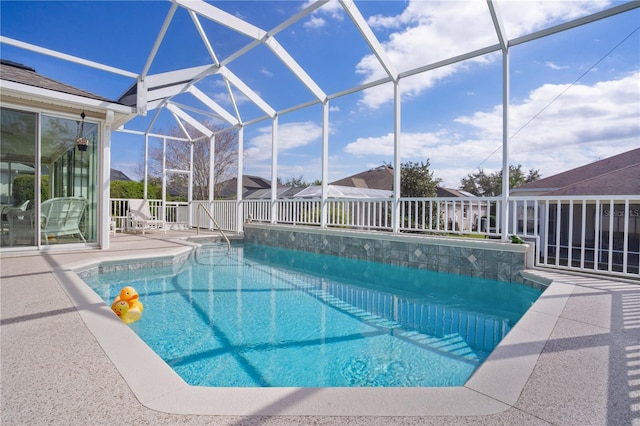 view of swimming pool featuring a patio and a lanai