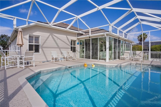 view of pool with a patio and a lanai