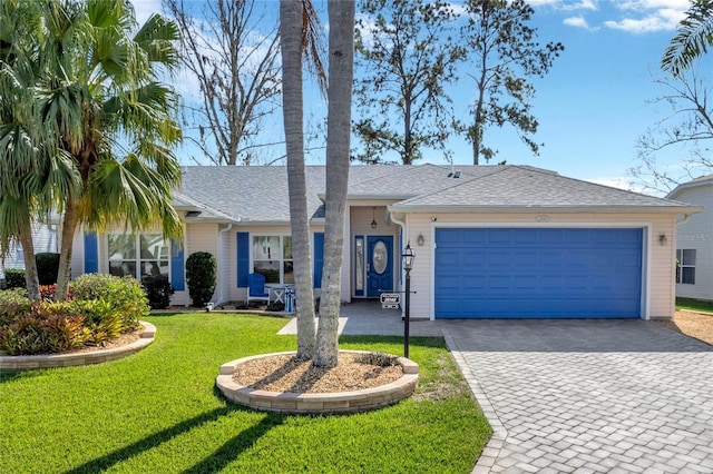 single story home featuring a garage and a front yard