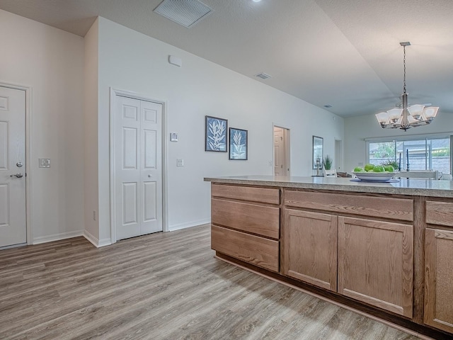 bathroom featuring a notable chandelier and hardwood / wood-style flooring