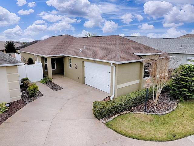 single story home featuring a garage and a front lawn