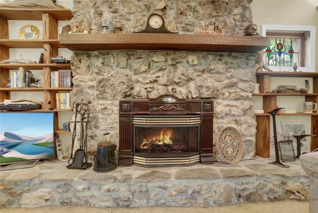 interior details featuring a stone fireplace