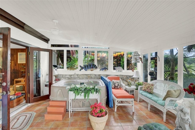 sunroom with vaulted ceiling, ceiling fan, and wood ceiling