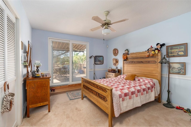 carpeted bedroom with access to outside and ceiling fan