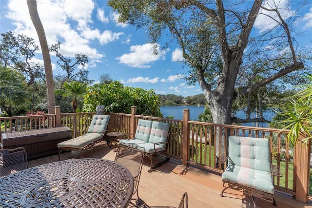 deck with a water view and an outdoor living space