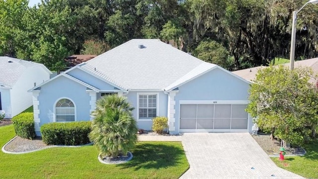 view of front of property with a garage and a front yard