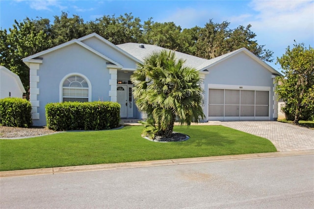 ranch-style home with a garage and a front yard