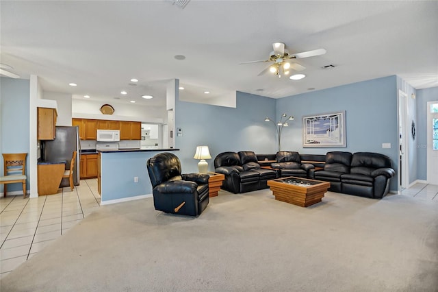 living room with ceiling fan and light colored carpet